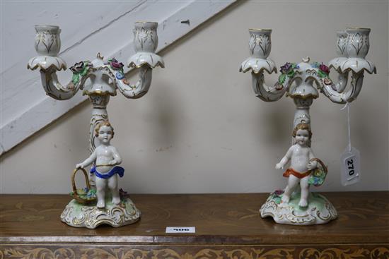 A pair of floral encrusted figural four branch candelabra
